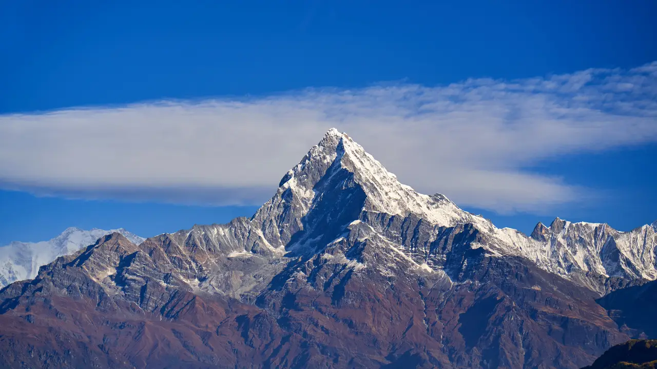 Snow peak above the cloud line — high-altitude operations